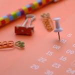 A close-up of colorful office supplies featuring a calendar, perfect for planning and organization themes.